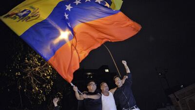 Venezuelan opposition supporters celebrate the results of the legislative election in Caracas, on December 7, 2015 as Venezuela's opposition won a majority of 99 out of 167 seats in the state legislature – the first such shift in power in congress in 16 years. Luis Robayo/AFP Photo