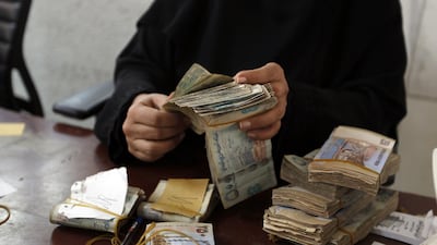 The Yemeni rial has dropped from about 215 to the US dollar at the start of the country's civil war to about 500 in January 2018. Mohammed Huwais / AFP