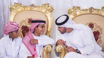 The Crown Prince of Abu Dhabi, Sheikh Mohammed bin Zayed, speaks with young guests while meeting the family of Hamed Mohamed Abbas Al Bloushi who was killed in the line of duty in Yemen on Friday. Wam