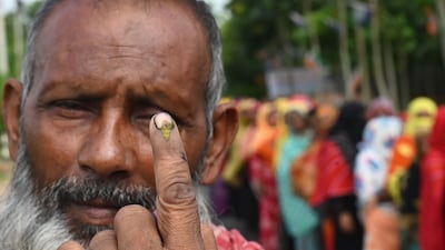 A voter outside a polling station on the outskirts of Kolkata shows his ink-marked finger after casting his vote for West Bengal's Panchayat, or local elections, on Saturday, July 8. All photos: AFP
