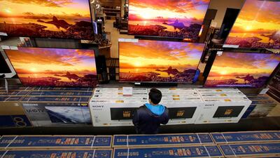 A man looks at televisions during an early Black Friday sale at a Best Buy store, in Overland Park, Kansas. AP Photo