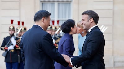 French President Emmanuel Macron, his wife Brigitte Macron, Mr Xi and Ms Peng greet each other before the state dinner. AFP