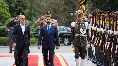 Mr Pezeshkian and Mr Al Zaidi review the honour guard during the welcoming ceremony. AFP