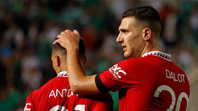 Manchester United defender Diogo Dalot, right, embraces teammate Anthony at the end f the Europa League match against Omonia Nicosia. AFP