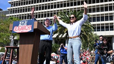 US Senator Bernie Sanders and US Representative Alexandria Ocasio Cortez, Democrat of New York, wave to supporters during the "Fighting Oligarchy: Where We Go From Here" rally at Gloria Molina Grand Park in Los Angeles on April 12. AFP