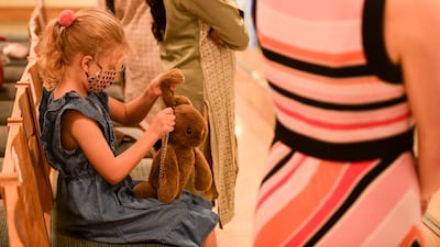 A young girl plays with her soft toy at St Andrew's Abu Dhabi. Khushnum Bhandari / The National