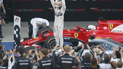 Lewis Hamilton celebrates atop his car after winning the Japanese Grand Prix. Toru Hanai / Reuters