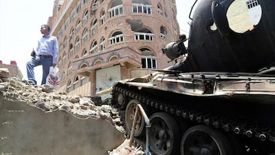 A Yemeni stands next to a tank during clashes between fighters from the Popular Resistance Committees, loyal to Yemen's exiled president Abdrabu Mansur Hadi, and Houthi rebels in Taez city on August 23, 2015. Ahmad Al Basha / AFP