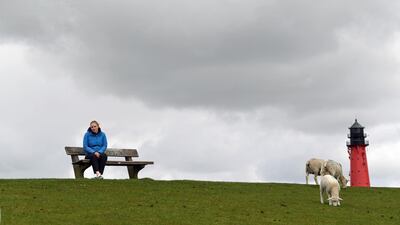 Sophie Backsen, 22, daughter of a farming family, which forced Germany by court to tighten its climate law, sits on a dyke on the North Sea island of Pellworm, Germany May 3. Reuters