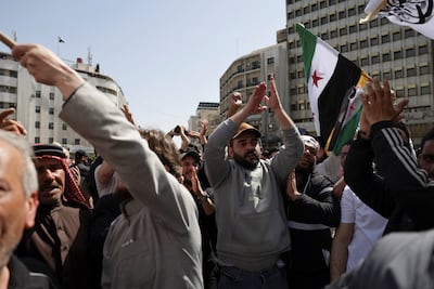People chanting at the protest in Damascus. Reuters