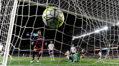 Barcelona’s Argentinian forward Lionel Messi (2R) scores during the Spanish league football match FC Barcelona v Valencia CF at the Camp Nou stadium in Barcelona on April 17, 2016. AFP / JOSEP LAGO
