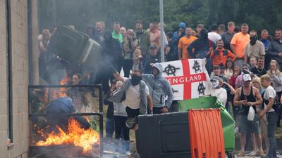 Rioter attempts to set fire to a hotel housing asylum seekers in Rotherham, northern England. Reuters