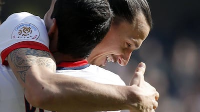 Zlatan Ibrahimovic (R) of Paris Saint-Germain celebrates with teammate Angel Di Maria (L) after scoring during the French Ligue 1 match between Estac Troyes and Paris Saint-Germain (PSG) at the Aube stadium in Troyes, France, 13 March 2016. PSG clinches 4th straight Ligue 1 title. EPA/YOAN VALAT