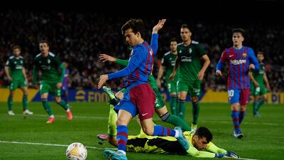 Barcelona midfielder Riqui Puig shoots to score a goal against Osasuna. AFP