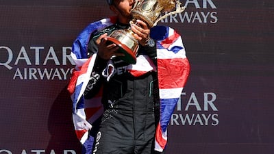 Lewis Hamilton celebrates with the trophy after winning the British Grand Prix. Reuters