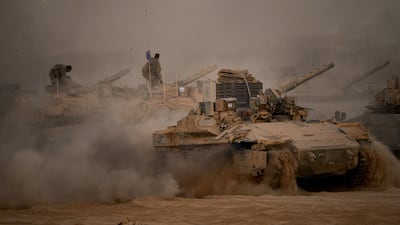 Israeli tanks and crews along the Israeli-Gaza border, as seen from southern Israel after a ceasefire came into effect. AP