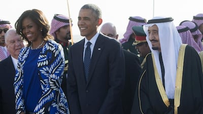 King Salman, right, walks alongside President Obama, centre, and first lady Michelle Obama. Saul Loeb/AFP Photo
