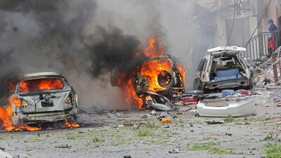 Vehicles burn outside a popular mall after a car bomb attack the Mogadishu on July 30, 2017. The Al Qaeda-affiliated Al Shabab group frequently carries out deadly bombings in the Somali capital. Farah Abdi Warsameh / AP Photo