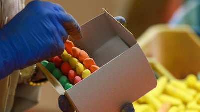 A worker packages finished chalk into boxes at the Jordan Chalk company in Karak, around 120 kilometres (70 miles) south of the capital Amman on June 13, 2022. - Long before whiteboards, beamers and laptops entered modern school classrooms, teachers relied on the humble, dusty, sometimes screechy blackboard chalk -- a material that has created a Jordanian business success story. (Photo by Khalil MAZRAAWI / AFP)