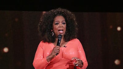 Oprah Winfrey wears a fitted sequinned orange gown on stage during her 'An Evening With Oprah' in Melbourne, Australia on tour on December 2, 2015. Getty Images