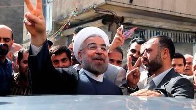 Hassan Rowhani (centre) flashes the victory sign after voting in Tehran during the first round of the presidential election.