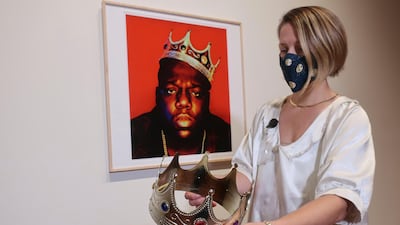 Sotheby's specialist Cassandra Hatton holds the plastic crown worn and signed by the Notorious BIG. Photographer Barron Claiborne provided the crown prop to portray Biggie Smalls as the king of New York during a 1997 photo shoot for the cover of 'Rap Pages' magazine, held three days before the rapper was killed. AP photo