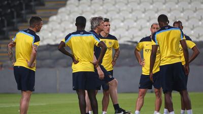 Manager Manuel Pellegrini talks with players during Manchester City's training session on Wednesday in Abu Dhabi at Al Jazira Club's Mohammed bin Zayed Stadium. Marwan Naamani / AFP / May 14, 2014