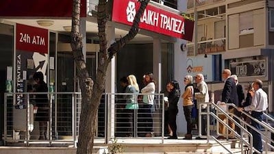 Customers queue up outside a branch of Cyprus Popular Bank in Nicosia. Patrick Baz / AFP Photo