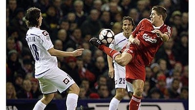 Fiorentina's Riccardo Montolivo, left, challenges Liverpool's Steven Gerrard during the Champions League match at Anfield.