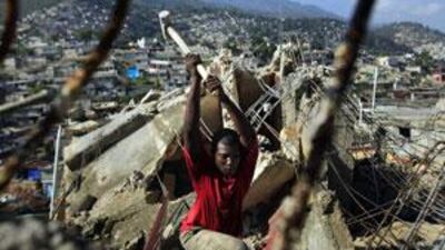 A public employee works on the demolition of a collapsed building in the Pacot neighbourhood of Port-au-Prince.