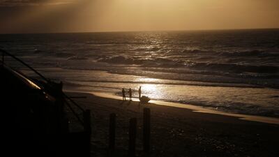 Palestinians on the beach at Deir Al Balah in the southern Gaza Strip on December 24. EPA