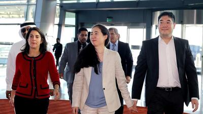 Grace and Matthew Huang, centre and right, walking with US ambassador to Qatar, Dana Shell Smith, left, at the Hamad International Airport in Doha on December 3, 2014. The couple who were cleared of charges in their adopted daughter’s death were earlier prevented from leaving the country despite being cleared of any charges by the appeals court in Doha. Osama Faisal/AP Photo