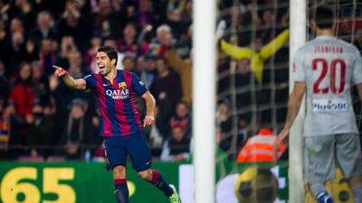 Luis Suarez of Barcelona celebrates after scoring his team's second goal during their 3-1 La Liga win over Atletico Madrid on Sunday. Alex Caparros / Getty Images