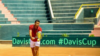 Egyptian tennis player Karim-Mohamed Maamoun prepares to serve during a Davis Cup match. All photos by Mohamed Saeed