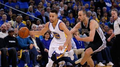 Golden State Warriors guard Stephen Curry dribbles round Manu Ginobili of the San Antonio Spurs during their NBA contest. Ezra Shaw / Getty Images / AFP