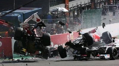 Fernando Alonso, left, and Lewis Hamilton, right, are involved in the first lap collision that took them out of the Belgian Grand Prix.