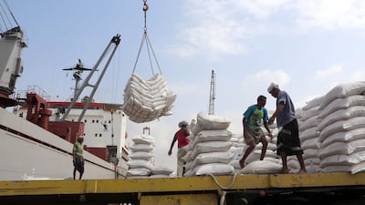 Workers unload wheat assistance provided by UNICEF from a cargo ship at the Red Sea port of Hodeida on January 27, 2018. AFP