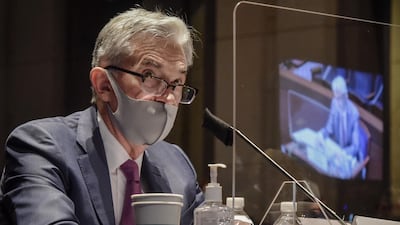Jerome Powell, Chairman of the US Federal Reserve, sits behind a protective barrier while wearing a protective mask during a House Financial Services Committee hearing in Washington this week. Bloomberg