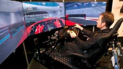 Pere Bascompte takes a test drive in a fully integrated F1 driving simulator at the CXC Simulations stand.