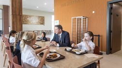 Harrow International School Abu Dhabi Headmaster Adrian Frost interacts with students during their lunch break at Harrow Dubai. Antonie Robertson/The National