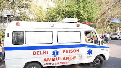 An ambulance carrying the bodies of four executed men enters Deen Dayal Upadhyay hospital in New Delhi. AFP