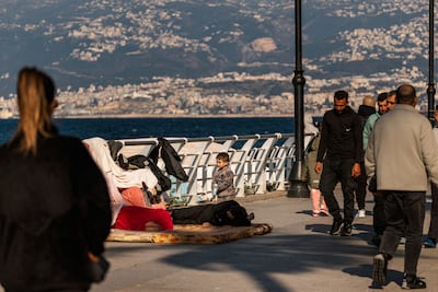 A displaced family sleep on Beirut's Corniche. AFP