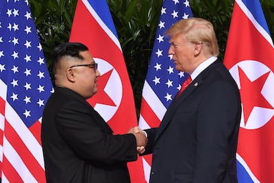 North Korea's leader Kim Jong-un shakes hands with Donald Trump at the start of their historic US-North Korea summit, at the Capella Hotel on Sentosa island in Singapore. AFP/SAUL LOEB