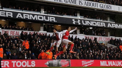 Arsenal's Chilean striker Alexis Sanchez (R) celebrates with Arsenal's Spanish defender Hector Bellerin (L) after scoring their second goal during the English Premier League football match between Tottenham Hotspur and Arsenal at White Hart Lane in London, on March 5, 2016. - RESTRICTED TO EDITORIAL USE. No use with unauthorized audio, video, data, fixture lists, club/league logos or 'live' services. Online in-match use limited to 75 images, no video emulation. No use in betting, games or single club/league/player publications. / AFP / ADRIAN DENNIS / RESTRICTED TO EDITORIAL USE. No use with unauthorized audio, video, data, fixture lists, club/league logos or 'live' services. Online in-match use limited to 75 images, no video emulation. No use in betting, games or single club/league/player publications.