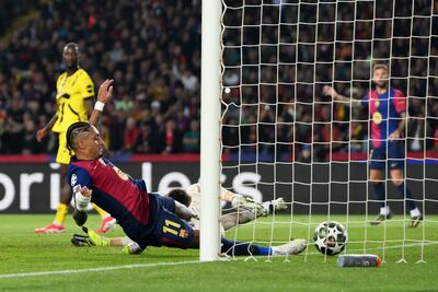 Barcelona's Raphinha slides home a shot from teammate Pau Cubarsi. Getty Images