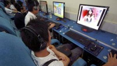 Customers use computers at an internet cafe in Suining, Sichuan province, on June 10 2009.