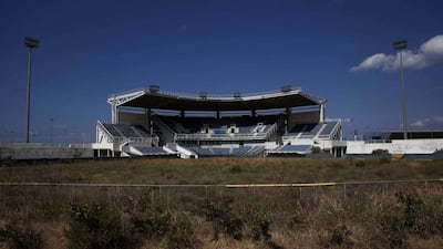 The abandoned stadium that hosted the softball competition during the 2004 Athens Olympic Games is seen at the Hellenikon complex, south of Athens, on July 16, 2014. Ten years after Greece hosted the world's greatest sporting extravaganza, many of its once-gleaming Olympic venues have been abandoned while others are used occasionally for non-sporting events such as conferences and weddings. For many Greeks who swelled with pride at the time, the Olympics are now a source of anger as the country struggles through a six-year depression, record unemployment, homelessness and poverty. Just days before the anniversary of the Aug. 13-29 Games in 2004, many question how Greece, among the smallest countries to ever host the Games, has benefited from the multi-billion dollar event. Yorgos Karahalis / Reuters
