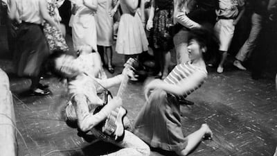 She loves you yeah yeah yeah: a teenage girl dances with a member of the Tokyo Beatles, a Beatles cover band, during a performance in Tokyo in 1964. Getty Images