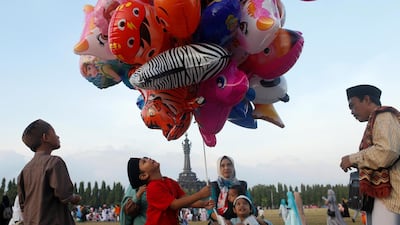 Muslim children play with balloons during Eid al-Fitr celebration at Puputan field in Denpasar, Bali, Indonesia. Reuters