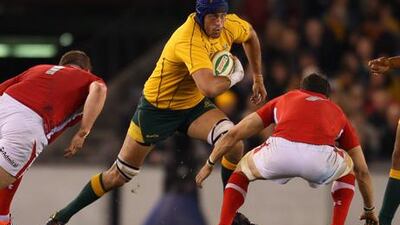 Nathan Sharpe runs with the ball against Wales at Etihad Stadium in Melbourne